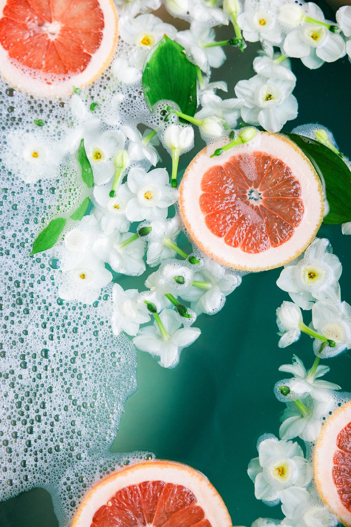 grapefruit and flowers in a bath tub
